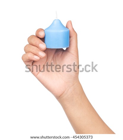 hand holding blue candle isolated on white background