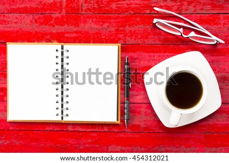 Office equipment on red table background for work.Such as notebook and pencil and and glasses and etc.