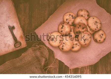 Homemade chocolate chip cookies on rustic wooden table, top view