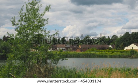 English countryside seen from a train to London, with selective focus on the horizon and motion blur on the foreground