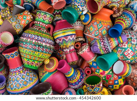 Pile of artistic painted handcrafted pottery vases Royalty-Free Stock Photo #454342600