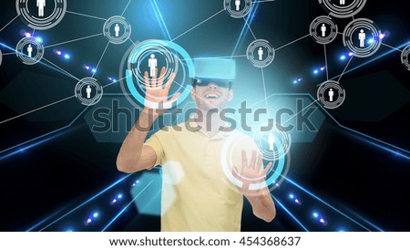 3d technology, virtual reality, cyberspace, network and people concept - happy young man in virtual reality headset or 3d glasses touching contact icons on screen over black background and laser light