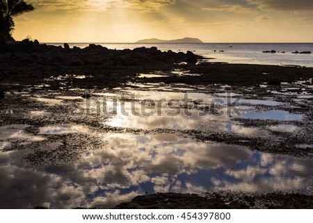 Sunset over  ocean islands. Reflection of clouds on  water surface. Beqa island. Fiji