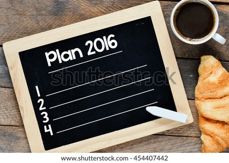 Plan 2016 handwritten with white chalk on a blackboard on a wooden background