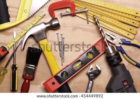 Assorted work tools on wood Royalty-Free Stock Photo #454449892