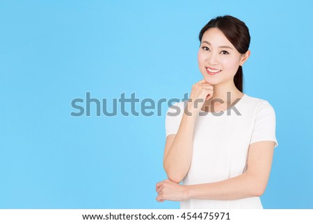 portrait of asian nurse isolated on blue background