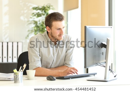 Confident businessman working on line with a computer at office near a window with natural light Royalty-Free Stock Photo #454481452