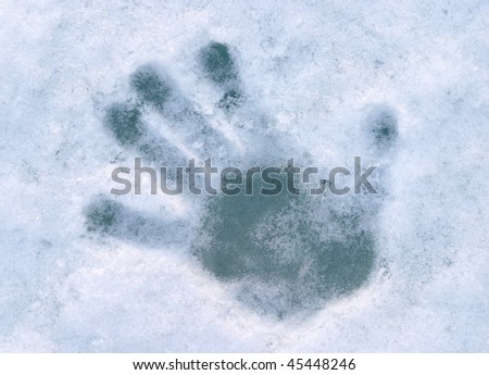 print of human palm on blue ice