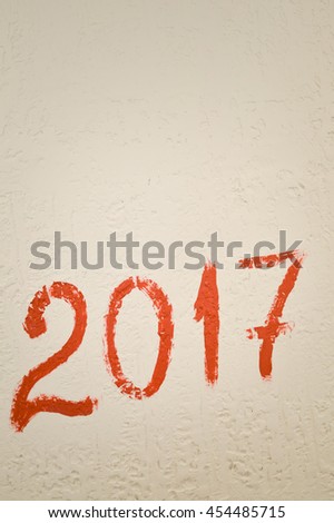 Sign of 2017 year written on light wall background, closeup view