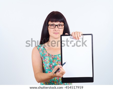 A young woman in glasses holding a blank document pointing where to put signature