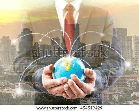 Double exporsure of businessman hand showing texture the world on screen stock market background with network diagram concept
