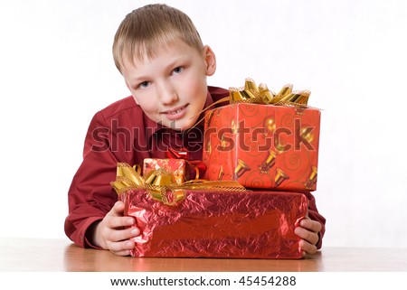 happy boy in a red shirt with gifts