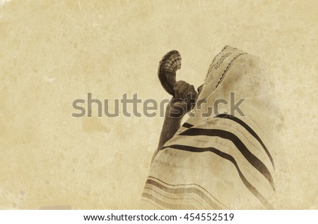 Jewish man blowing the Shofar (horn) of Rosh Hashanah (New Year). Religious symbol. Old style filter and overlay Royalty-Free Stock Photo #454552519