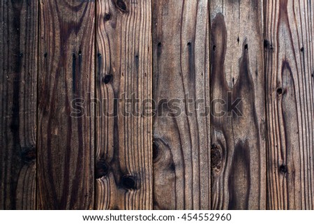 Dark brown wood planks, each with different pattern, not seamless, vertically aligned