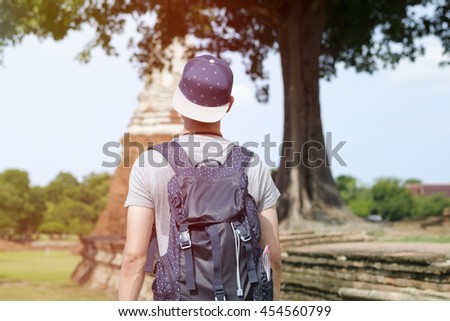 young man traveler temples  Asia with lighting of sunrise, travel and recreation concept