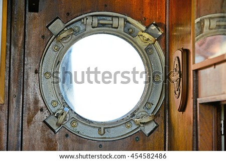 Porthole of an old boat. Royalty-Free Stock Photo #454582486