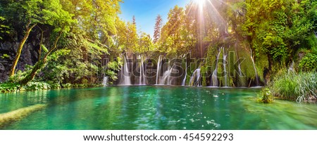 Breathtaking waterfalls panorama in Plitvice Lakes National Park, Croatia, Europe. Majestic view with turquoise water and sunset sunny beams, travel destinations background Royalty-Free Stock Photo #454592293