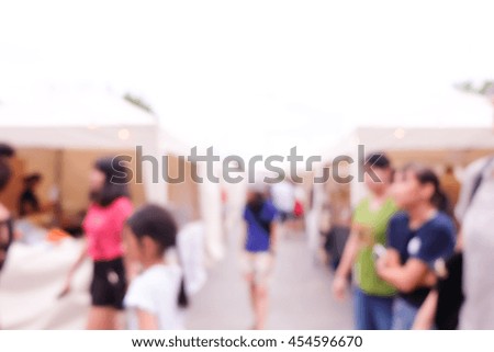blurred background of people walking in market.