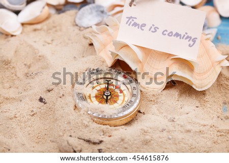 Compass in the sand with Message - Time is coming