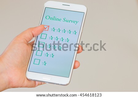 customer survey checking in online survey, feedback on smart phone with multiple-choice assessment by finger clicking : business concept