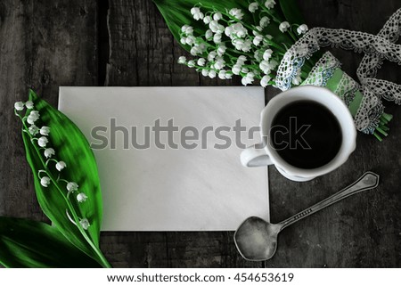 bouquet of lilies on wooden background and morning coffee