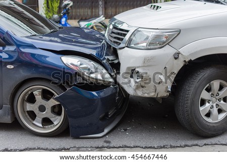 Car crash from car accident on the road in a city between saloon versus pickup wait insurance. Royalty-Free Stock Photo #454667446