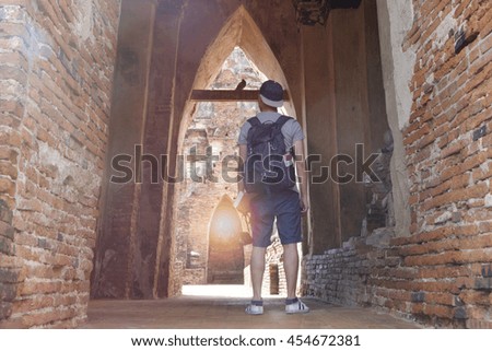 young man traveler temples  Asia with lighting of sunrise, travel and recreation concept 