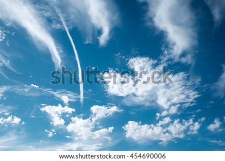 Jet smoke and deep blue sky with white clouds