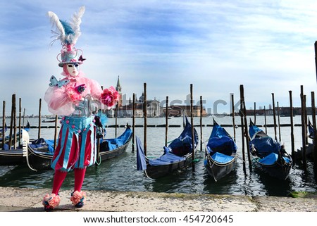 Venice. Carnival mask with gondolas in the background. Royalty-Free Stock Photo #454720645