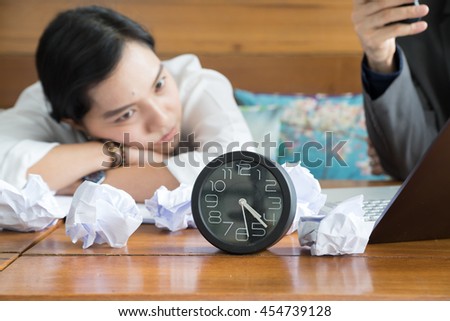 asian woman with clock on working table