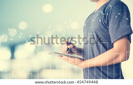 businessman using digital tablet with blurred background.Forex graph on the business background. A metaphor of international financial consulting.investment concept