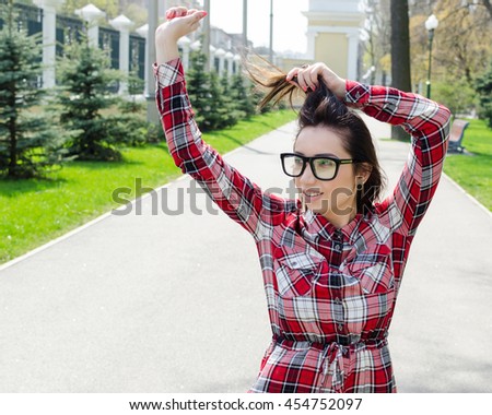 Woman street photo. Woman poses to camera, lifestyle outdoor photo.