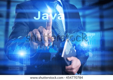 Businessman is pressing on the virtual screen and selecting "Java".