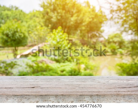 empty wood table with blurred garden park natural background