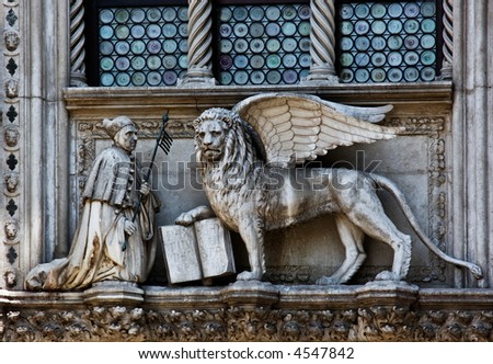 The Venetian lion and Doge on a cathedral building on San Marco square. Venice. Italy.