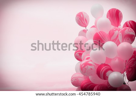 Bunch of fancy pink color balloons floating away in to the sky with vintage filter background  Royalty-Free Stock Photo #454785940