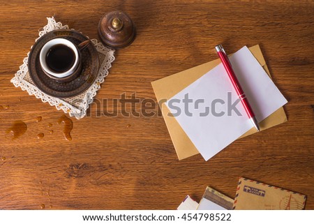 Envelopes on a wood background with a cup of coffee