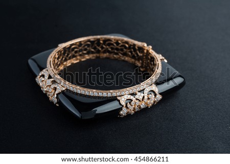 Black gemstone and diamond gold bracelet