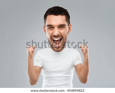 emotion, success, gesture and people concept - young man celebrating victory and screaming over gray background  (funny cartoon style character with big head)