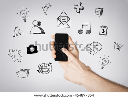 people, technology and communication - close up of hands with smartphone and media doodles over gray background