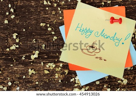 Morning message with text "Happy monday" written on yellow paper and attached to brown wooden plank. Copy space