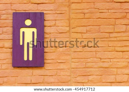 Men toilet sign on the brick