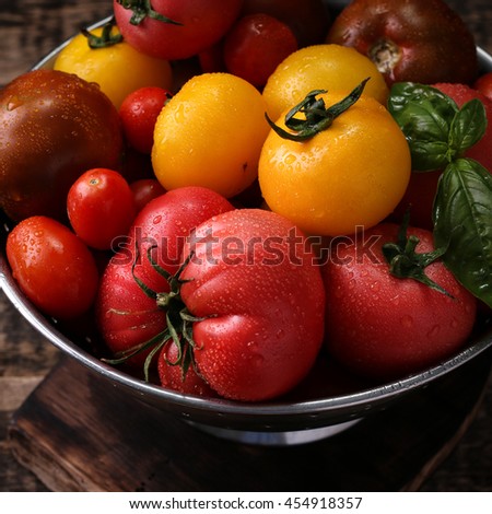 Colorful tomatoes, red , yellow , orange , green on vintage wooden background