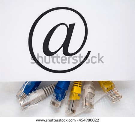 Twisted into a bundle of wire and patch cords. inscription e-mail sign.
