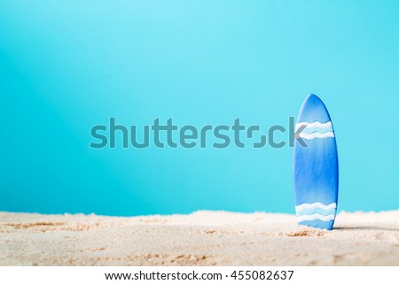 Summer theme with surfboard on a bright blue background