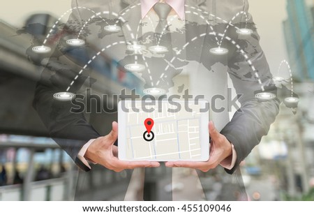 Businessman holding a tablet showing part of navigator map on connection line over the world map with blurred photo of traffic jam, Navigation concept,Elements of this image furnished by NASA