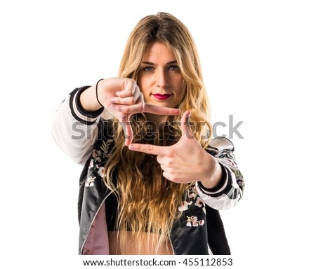 Pretty blonde woman focusing with her fingers