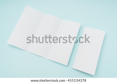 Trifold white template paper on blue background