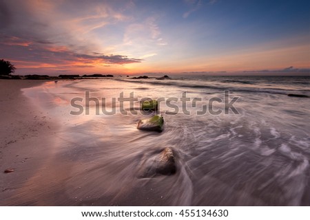 slow shutter waves trail during sunset at Kudat Sabah Malaysia. Image contain soft focus and blur.