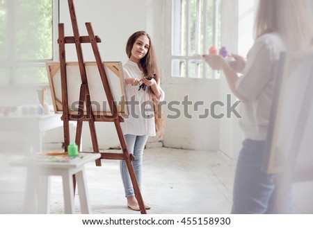 Art Lesson. little girl and woman teacher